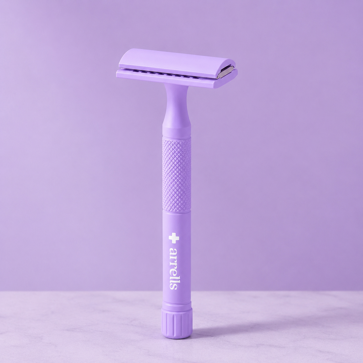 The arrells razor standing upright on a marble surface.